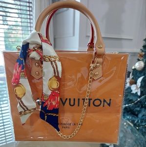 Authentic Louis Vuitton Shopping bag covered in clear PVC with handes.